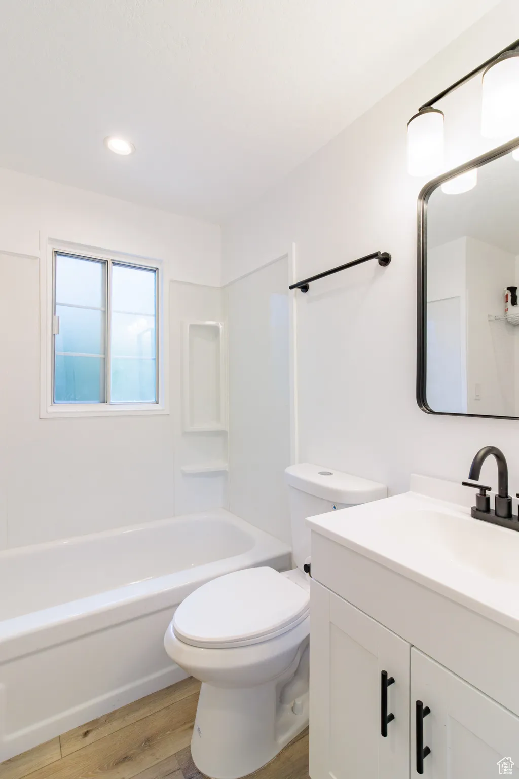 Full bath with vanity, light wood-type flooring, bathing tub / shower combination, and recessed lighting