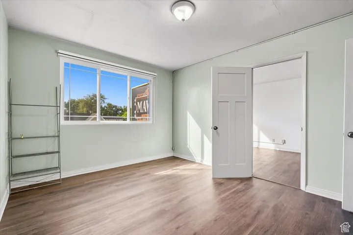 2 BR/2 BA Apartment bedroom featuring wood finished floors and baseboards