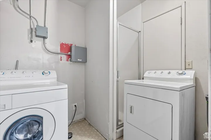 2 BR/2 BA Apartment Laundry room featuring light flooring and independent washer and dryer