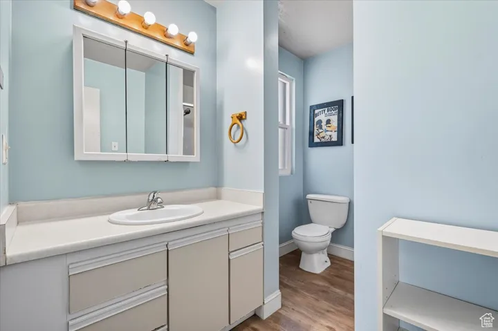 2 BR/2 BA Apartment Full bathroom featuring vanity and wood finished floors