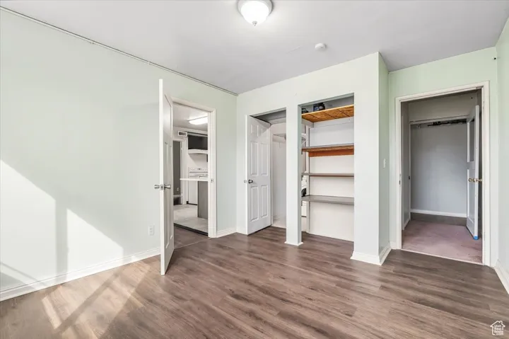 2 BR/2 BA Apartment bedroom with dark wood finished floors and baseboards