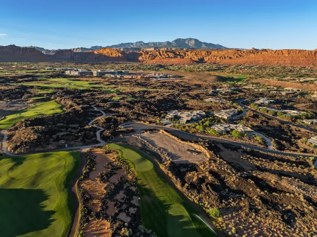 Expansive golf course frontage with manicured greens, surrounding desert landscaping, and prominent red rock mountain backdrop
