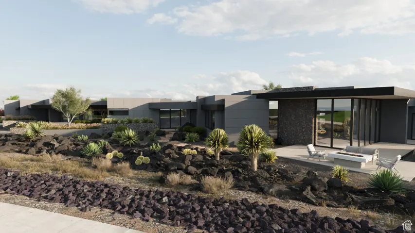 Rear view of house featuring a patio and stone siding