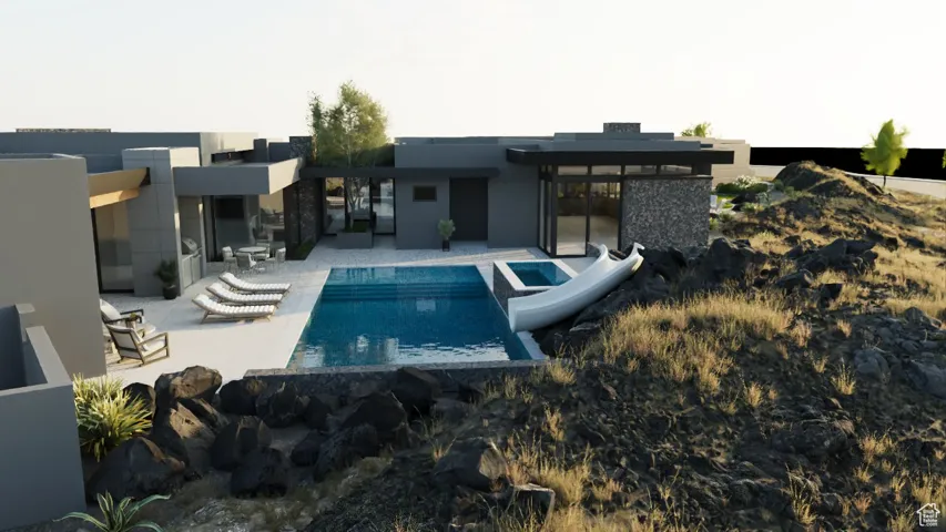 Swimming pool featuring a water slide and a patio area