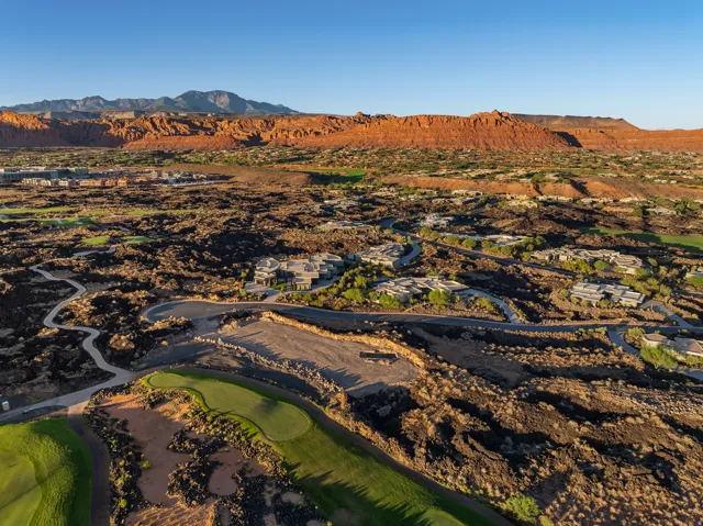 Expansive golf course community with natural rock formations and mountainous terrain