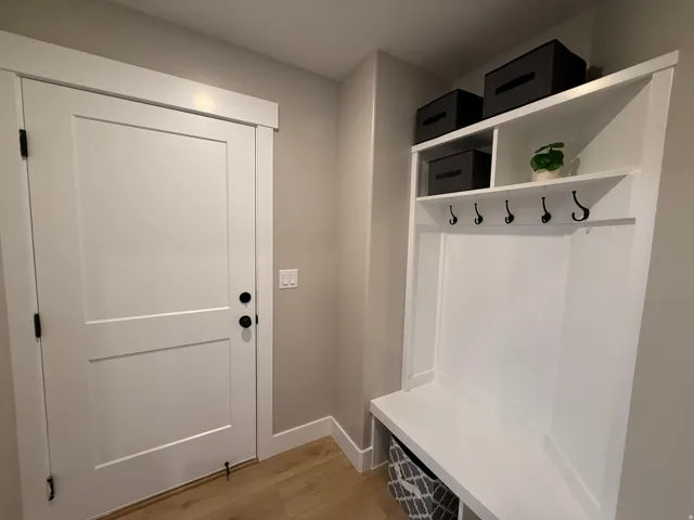 Mudroom with light wood-style flooring and baseboards