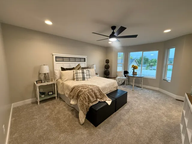 Carpeted bedroom with recessed lighting and ceiling fan