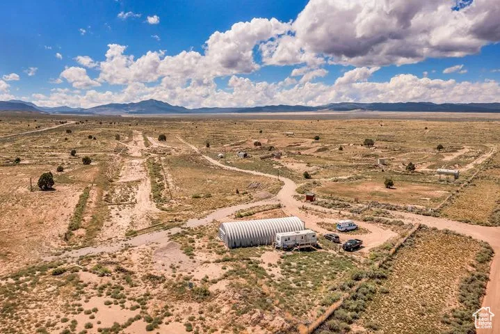 Aerial view of sparsely populated area featuring a desert landscape and a mountainous background