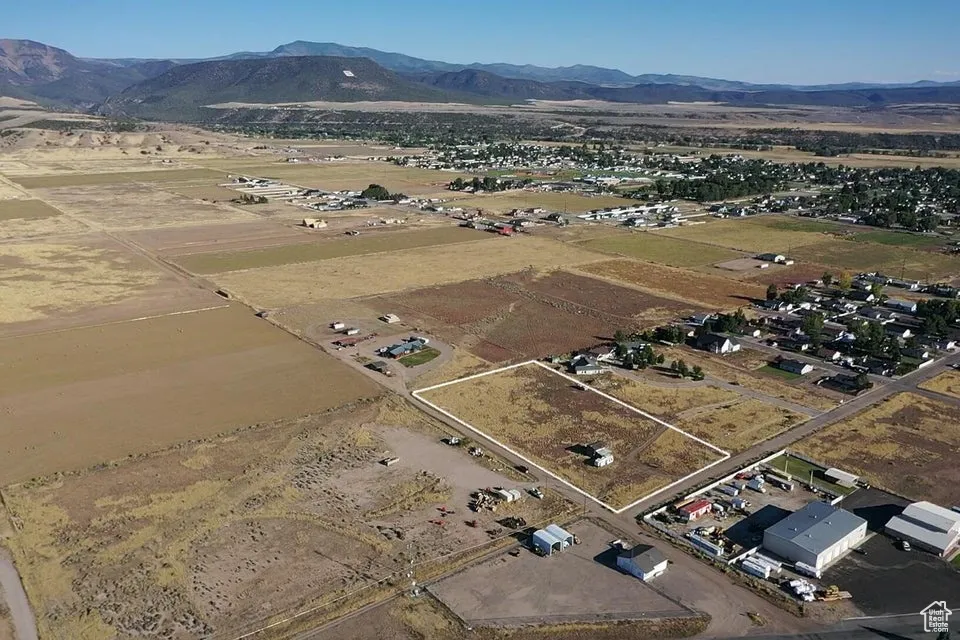 Aerial view of property's location with a mountainous background and rural landscape