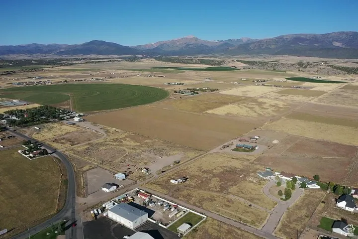 Aerial view of property's location with rural landscape and a mountainous background