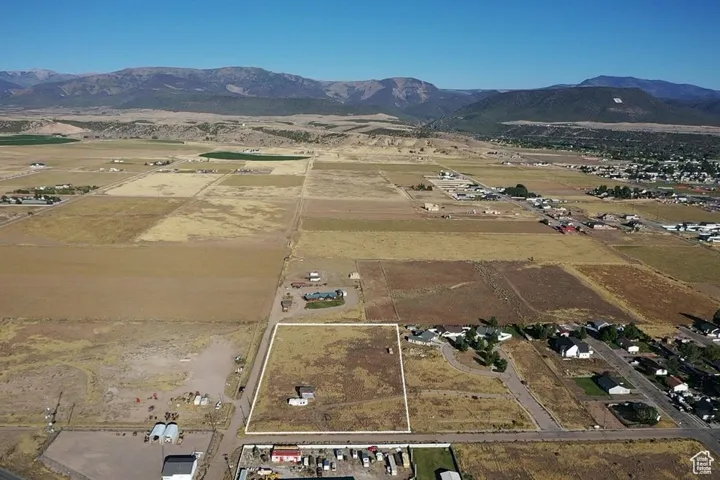 Aerial overview of property's location with a mountain backdrop and rural landscape