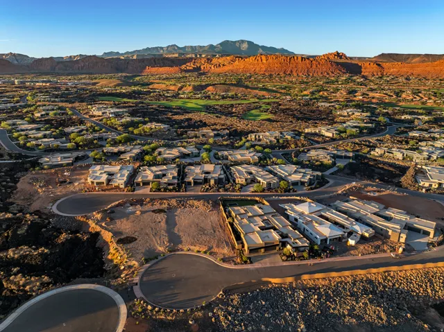 Residential development with a golf course, surrounded by mountainous terrain