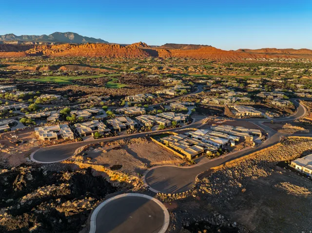 New construction development featuring modern architecture, surrounding natural rock formations, and desert landscaping