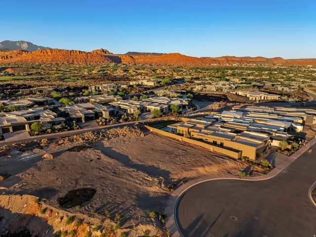 Expansive land parcel with surrounding residential properties and distant mountain backdrop