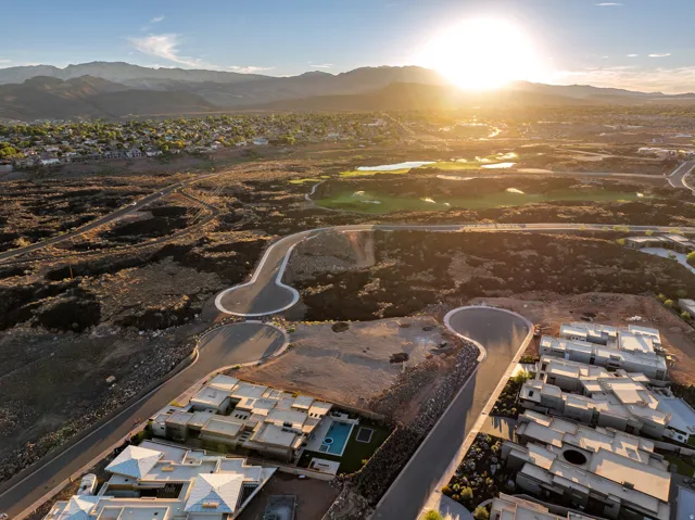 Aerial perspective of residential development, featuring multiple properties with contemporary architecture and private swimming pools