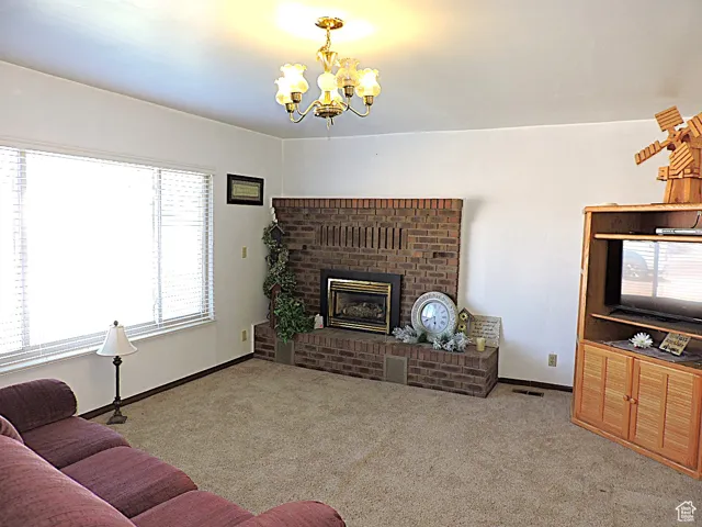 Carpeted living area featuring a fireplace