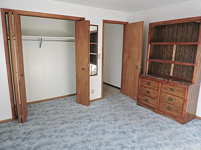 Unfurnished bedroom featuring a closet and carpet floors