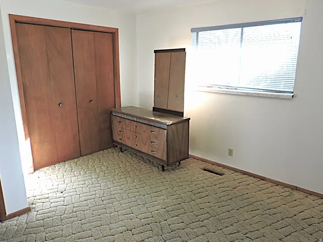 Unfurnished bedroom with a closet and carpet floors