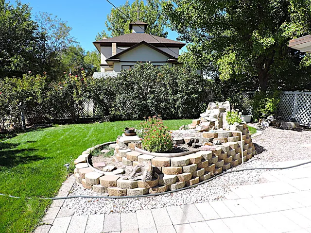 View of grassy yard featuring a patio