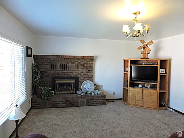 Living area with a fireplace, carpet