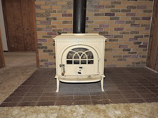 Detailed view of a wood stove and brick wall