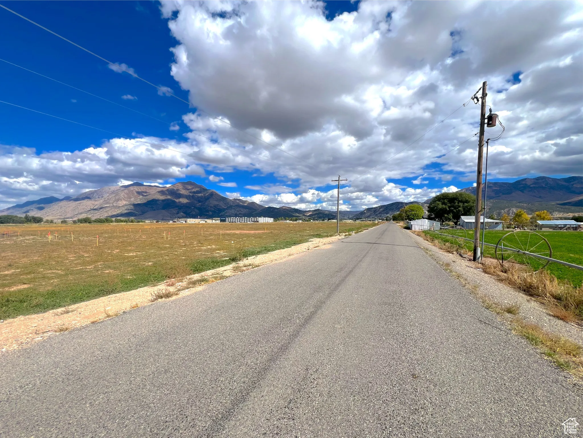 View of asphalt street with a mountain view and a rural view