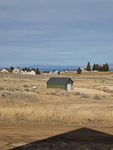 View of yard with an outbuilding and a rural view