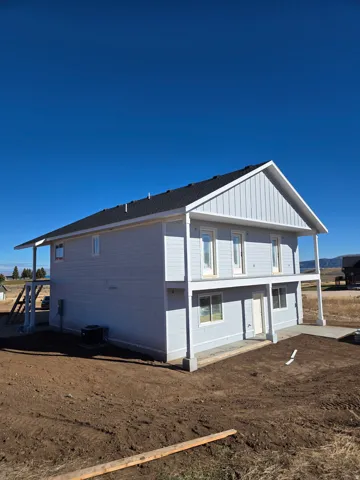 View of side of property featuring board and batten siding and a central air condition unit