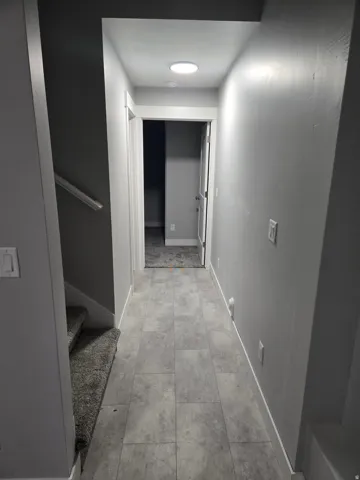 Hall with baseboards and stairs