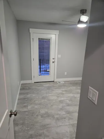 Entryway with baseboards and a ceiling fan