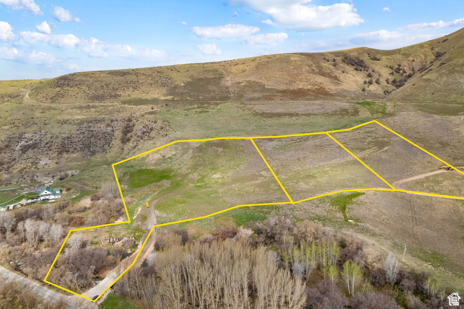 Overview of rural landscape featuring property boundaries highlighted and mountains