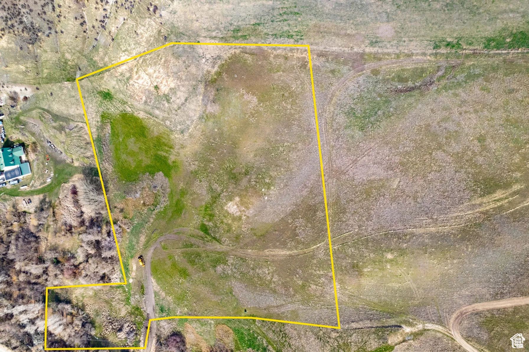 Aerial view of sparsely populated area with property parcel outlined