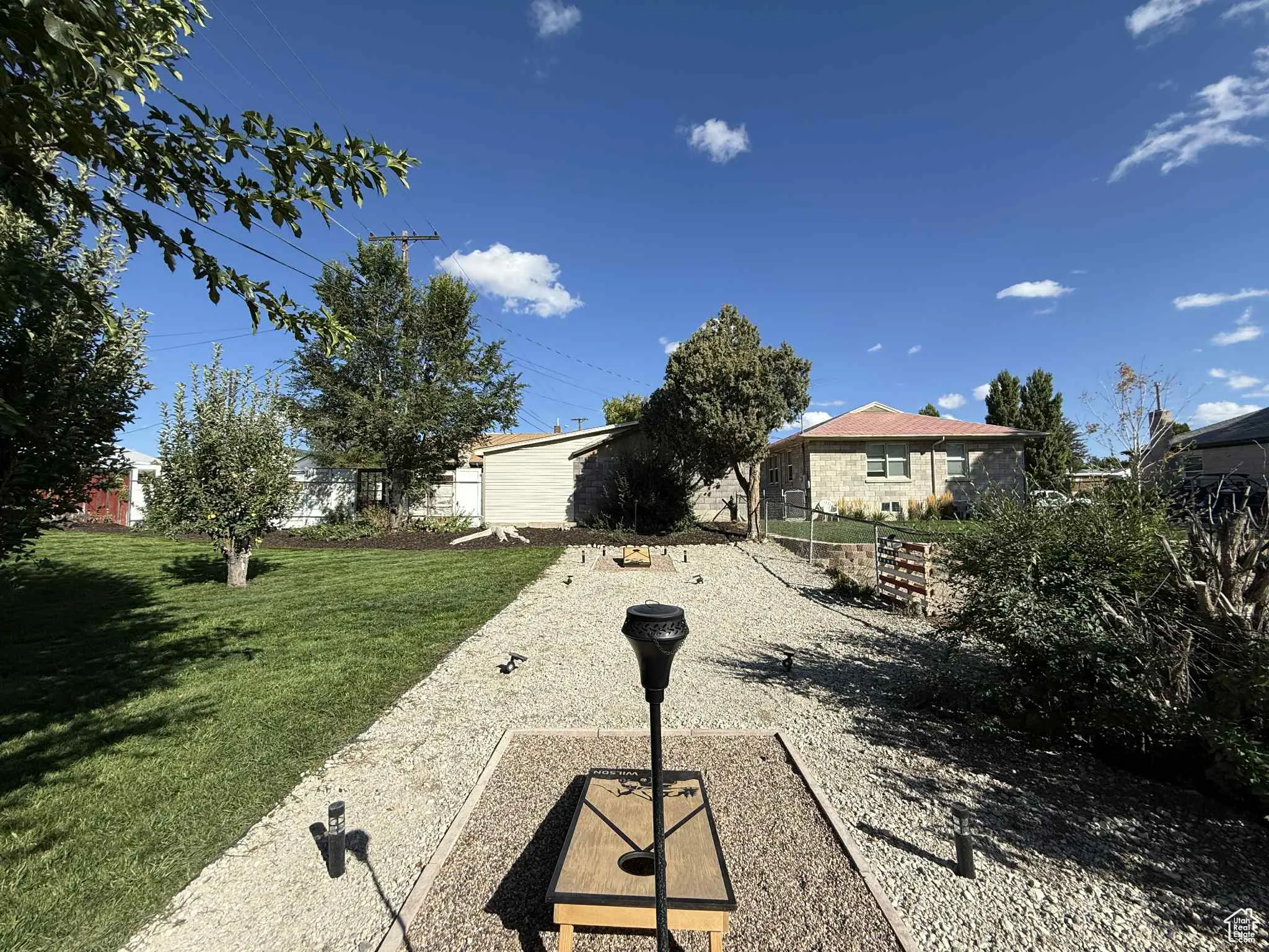 View of green lawn and featuring a cornhole area