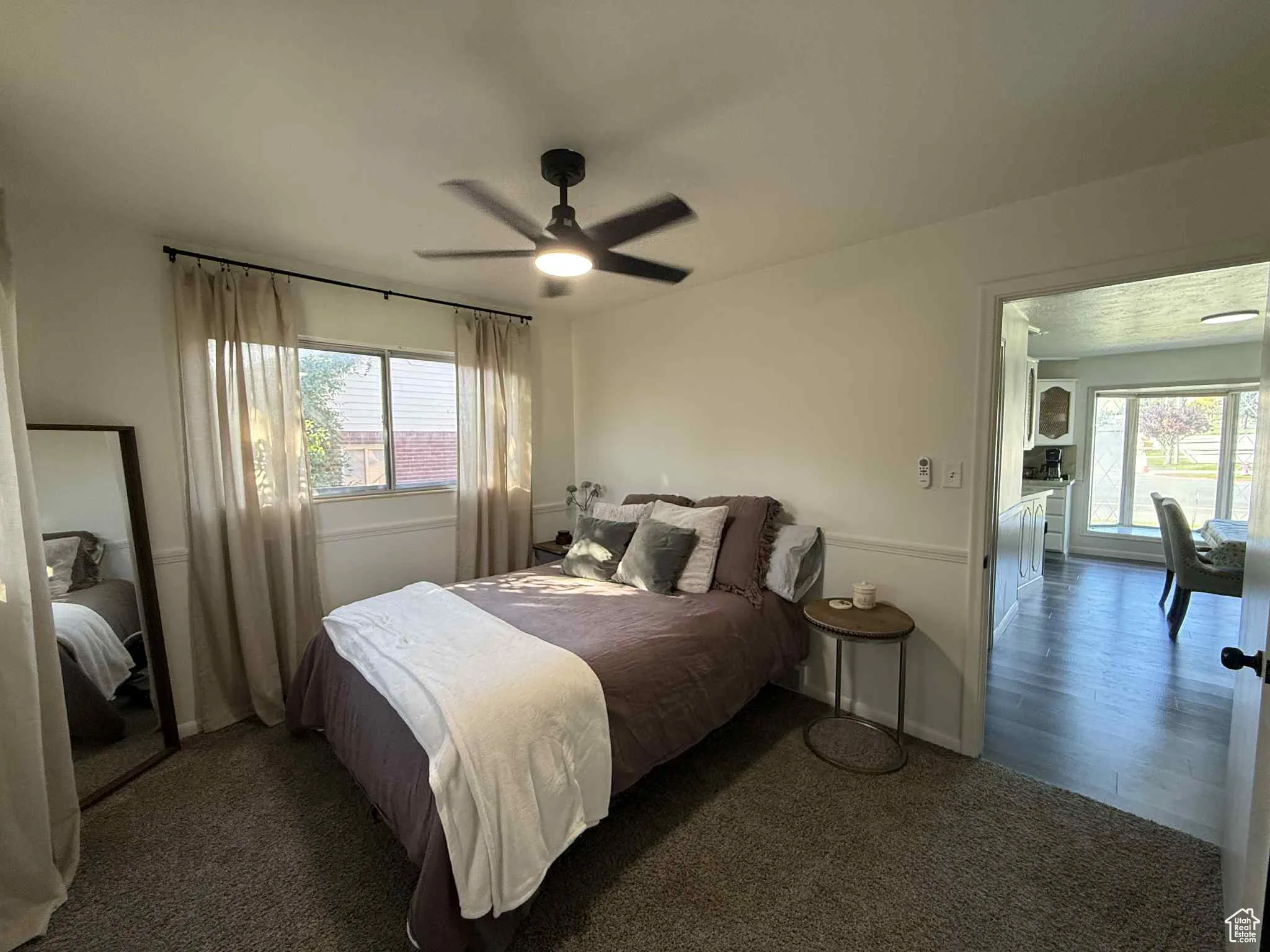 Carpeted bedroom with ceiling fan
