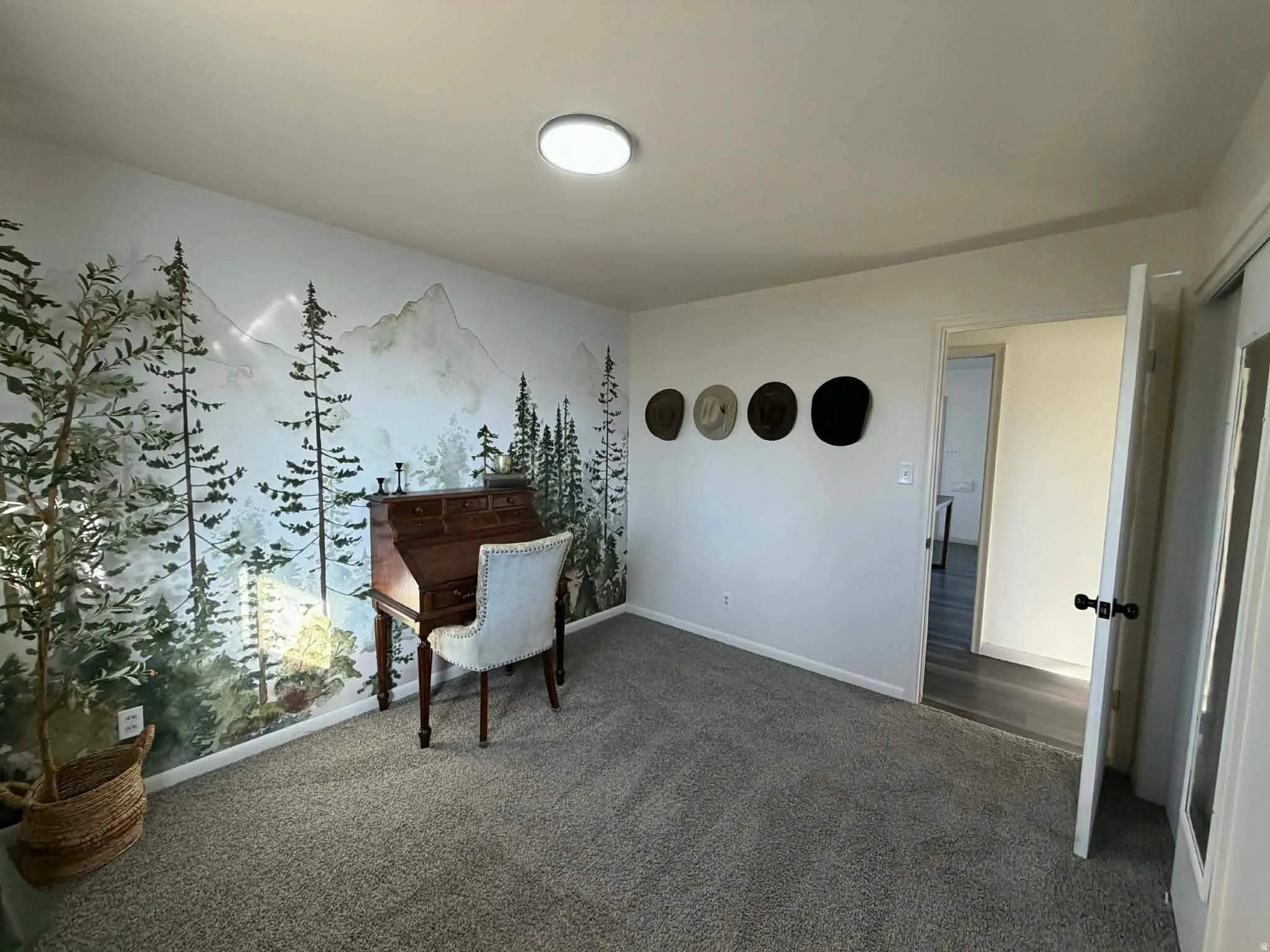 Office space with baseboards and dark colored carpet