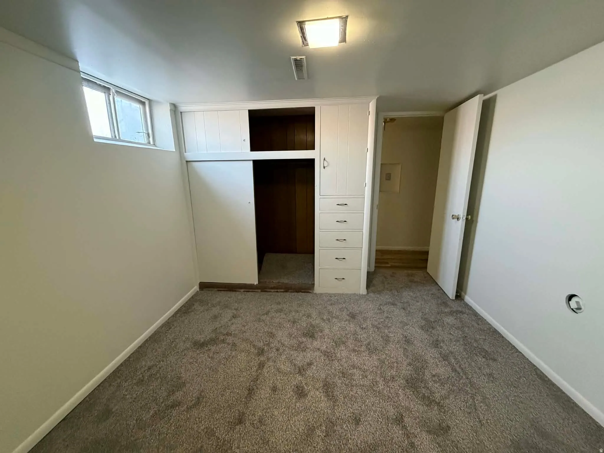 Unfurnished bedroom featuring a closet and carpet floors
