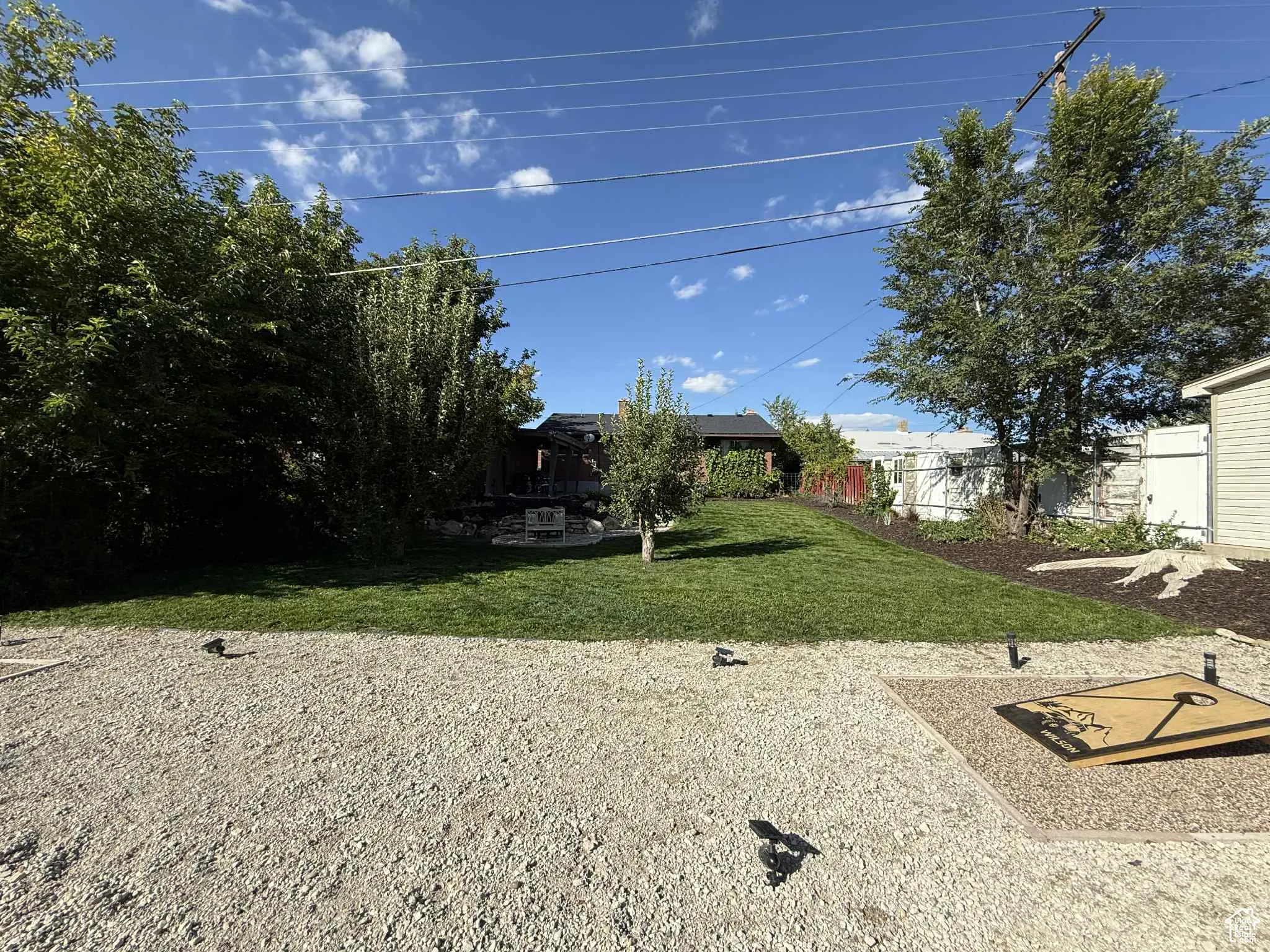 View of yard featuring a cornhole area