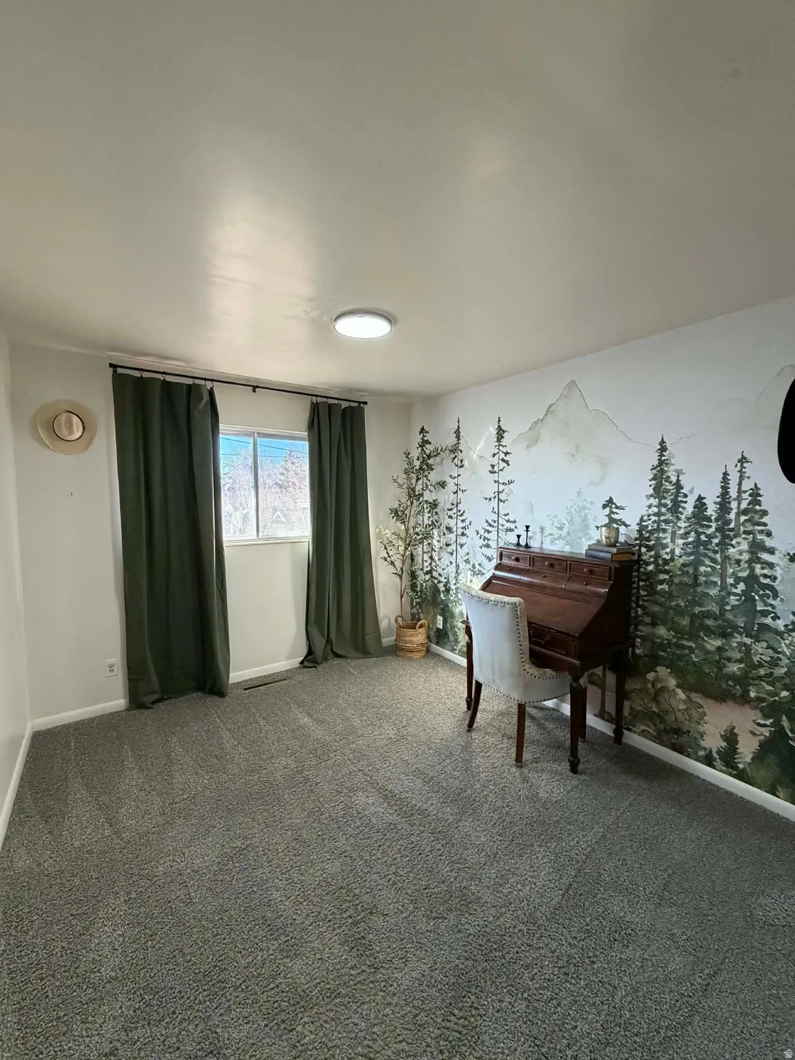 Living area featuring carpet flooring and baseboards
