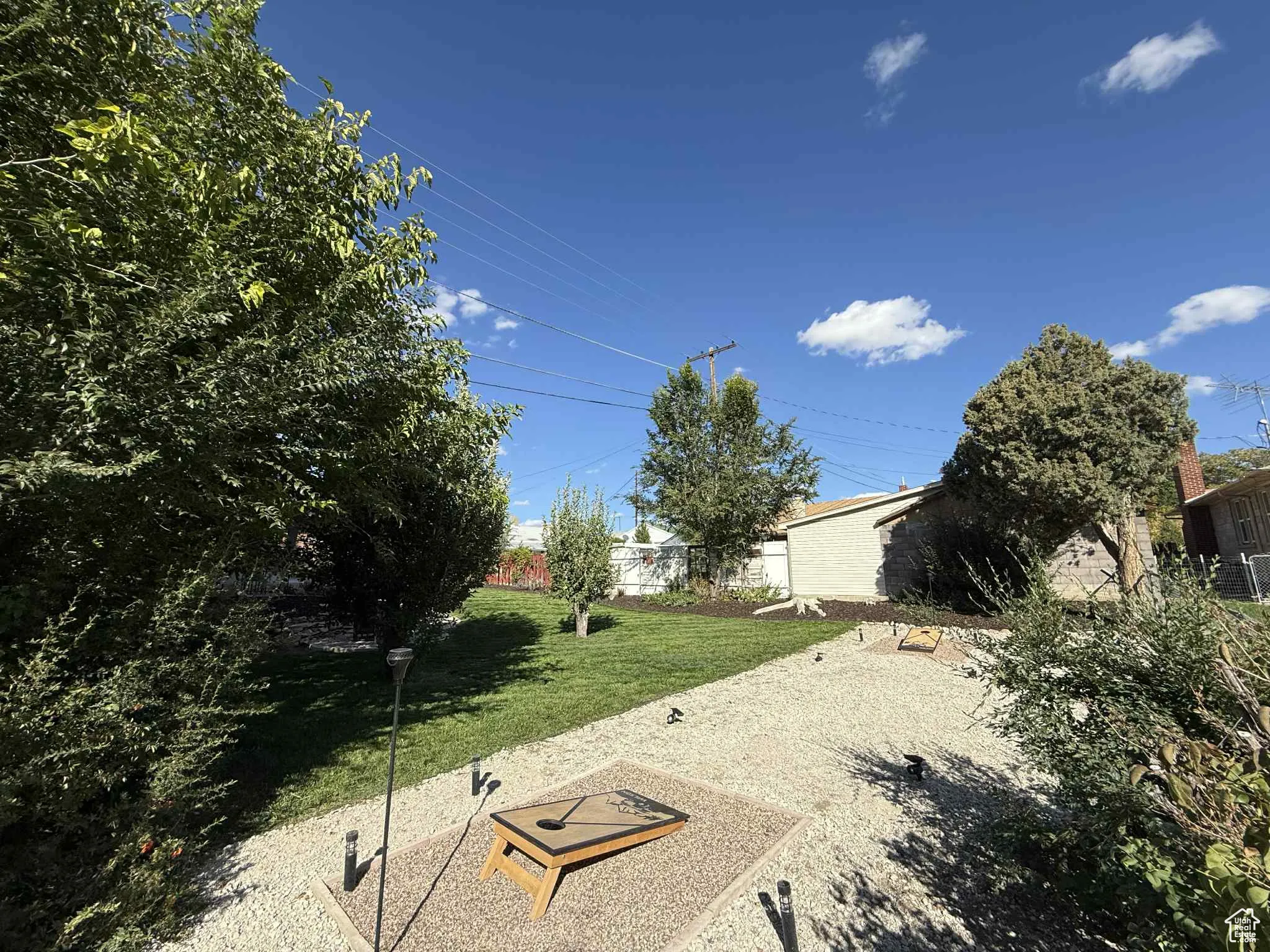 View of yard featuring a cornhole area