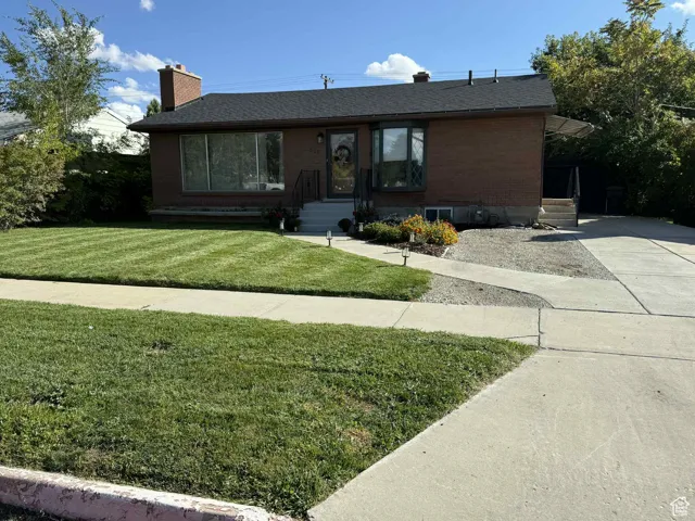 Ranch-style house with a front lawn, brick siding, a chimney, a brand new shingled roof as of 2025, and entry steps