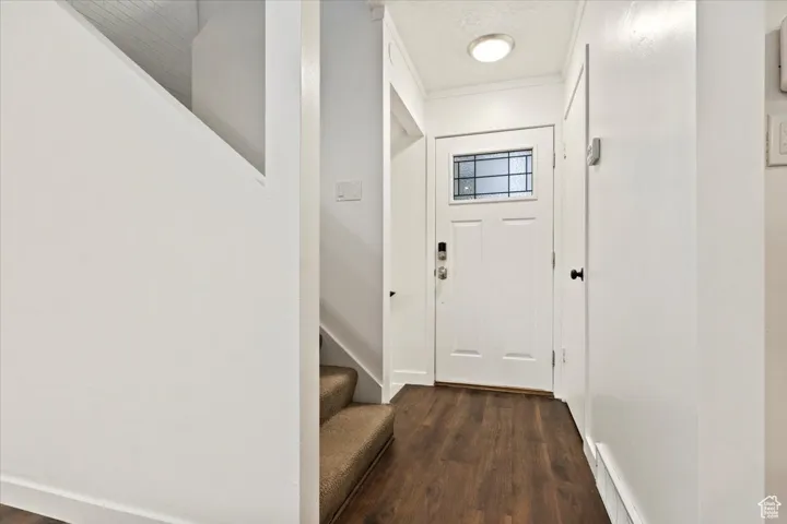 Doorway featuring wood finished floors and stairs
