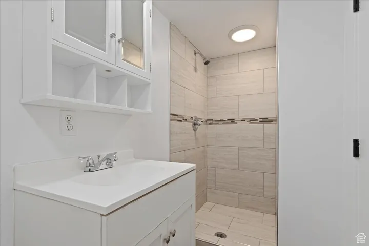 Bathroom featuring a stall shower and vanity