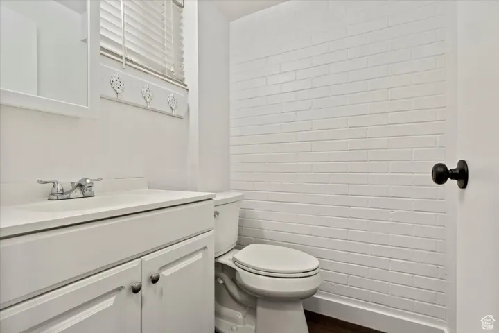 Bathroom featuring vanity and dark wood-style flooring