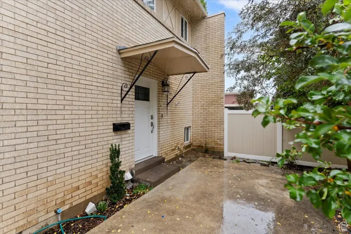 View of exterior entry with brick siding
