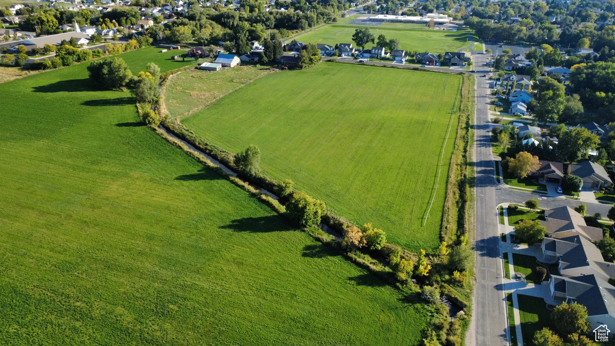 View of rural area with nearby suburban area and large plots for crops