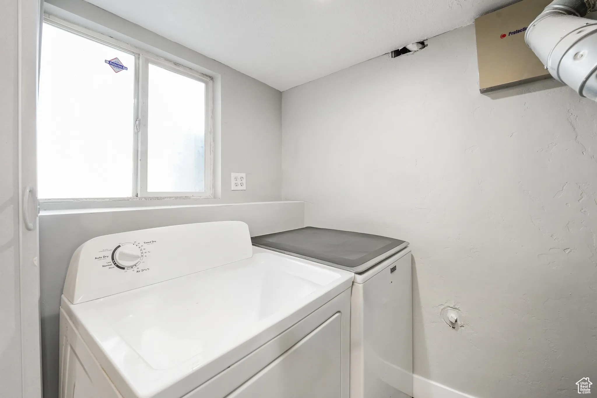 Laundry room with washer and clothes dryer