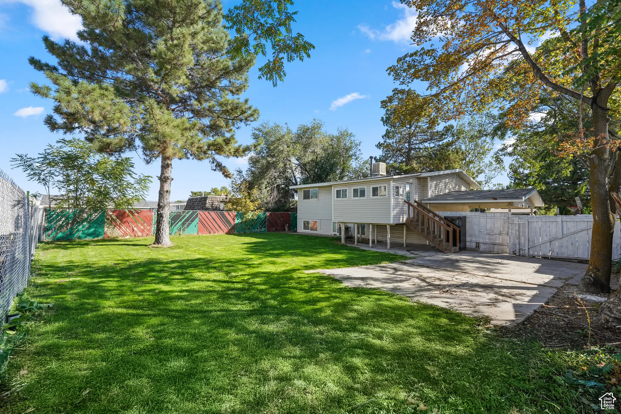 Fenced backyard featuring stairway, a patio area, and a gate