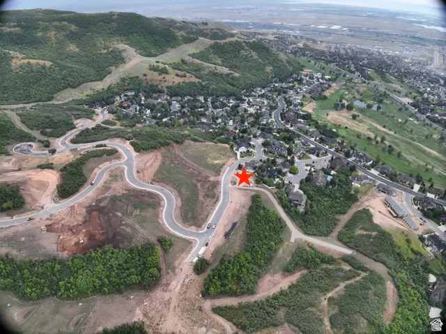 Aerial view of property's location with nearby suburban area