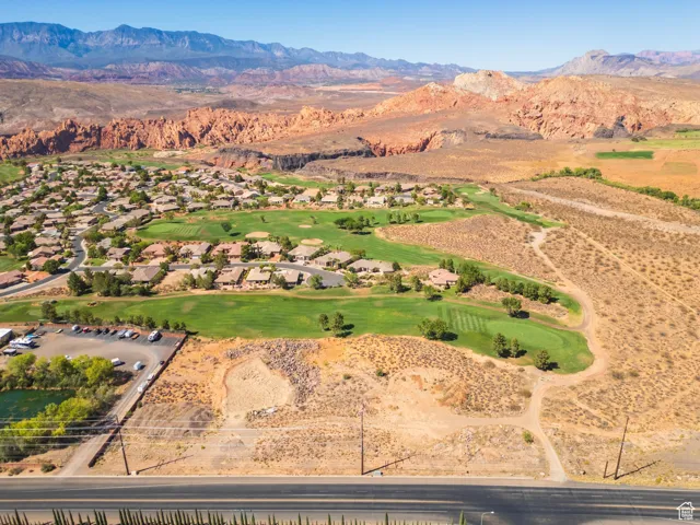 Aerial view of property's location with a mountainous background