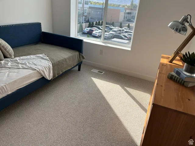 Sitting room with baseboards and carpet floors